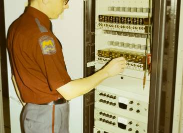 Adjusting equipment in a State Radio equipment rack (date unknown)